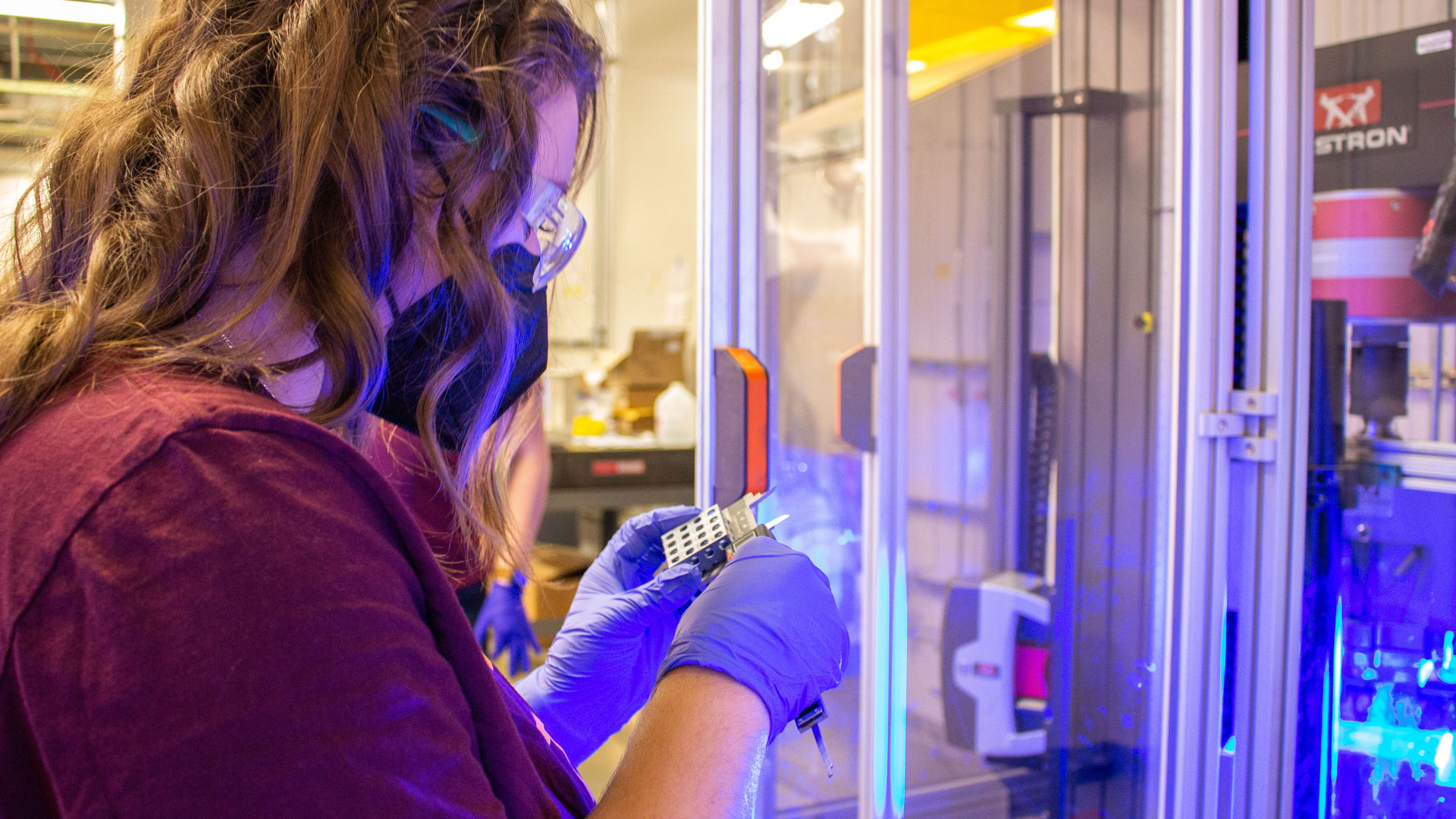 A student works on manufacturing research in a lab.