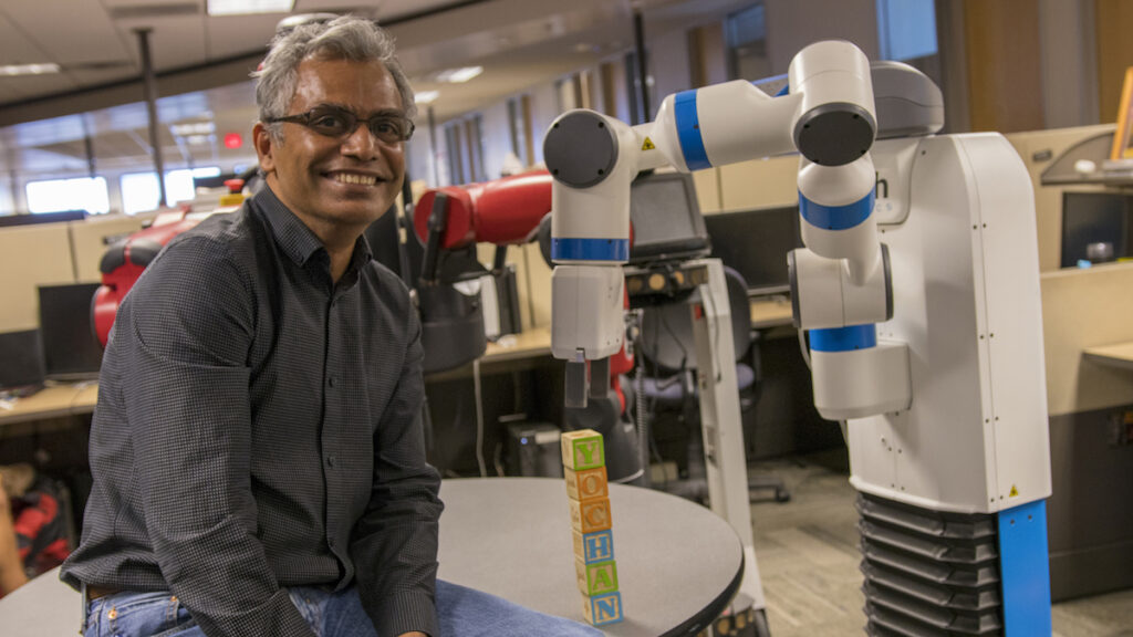 Subbarao Kambhampati poses with a robot