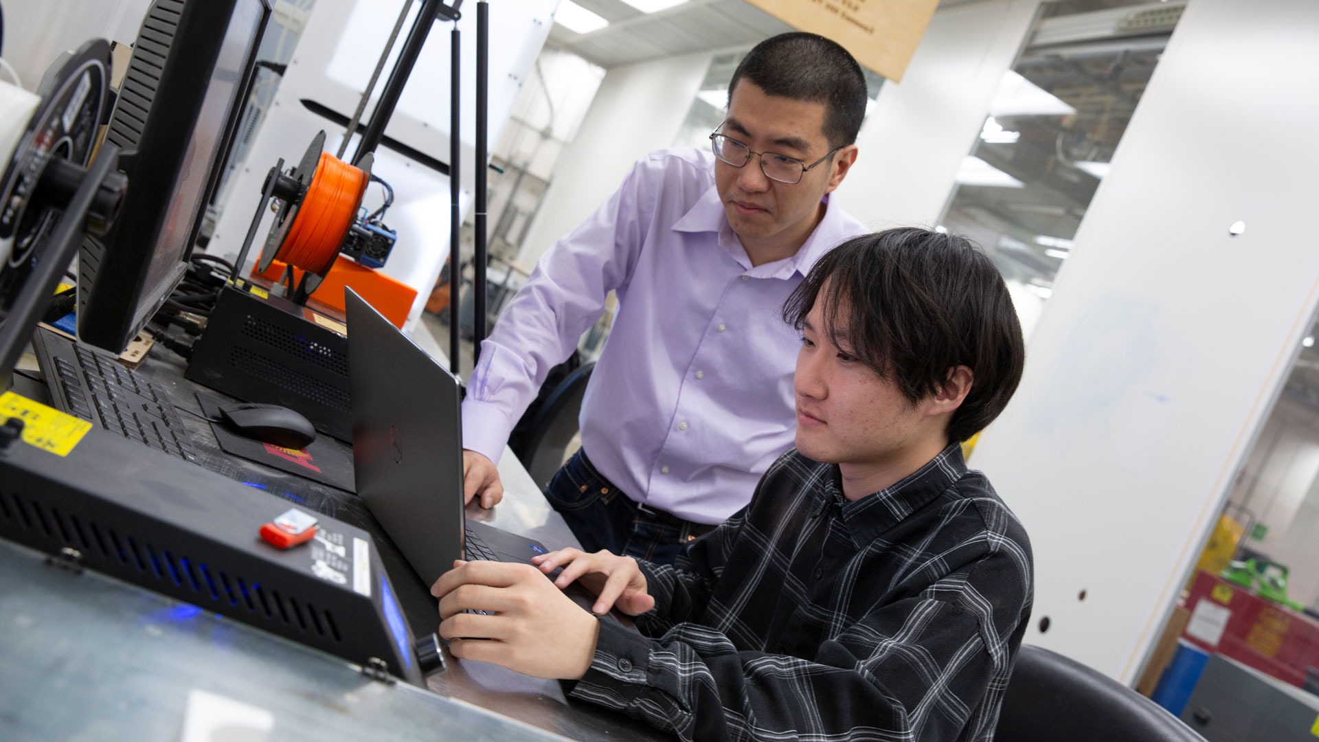 A student and faculty member work together in a lab.