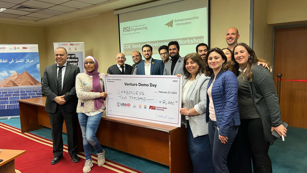 A group of people standing around a large check