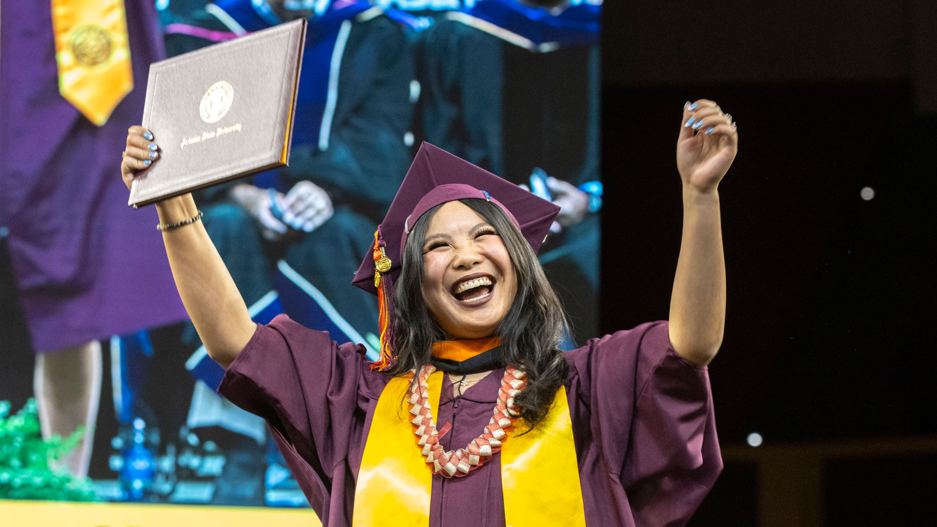 A graduate celebrates at Fulton Schools Convocation.